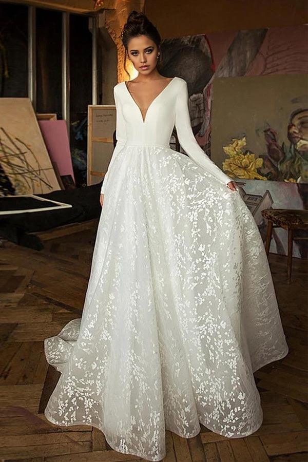 Elegant A-line V-neck long sleeve wedding dress for a beach ceremony.