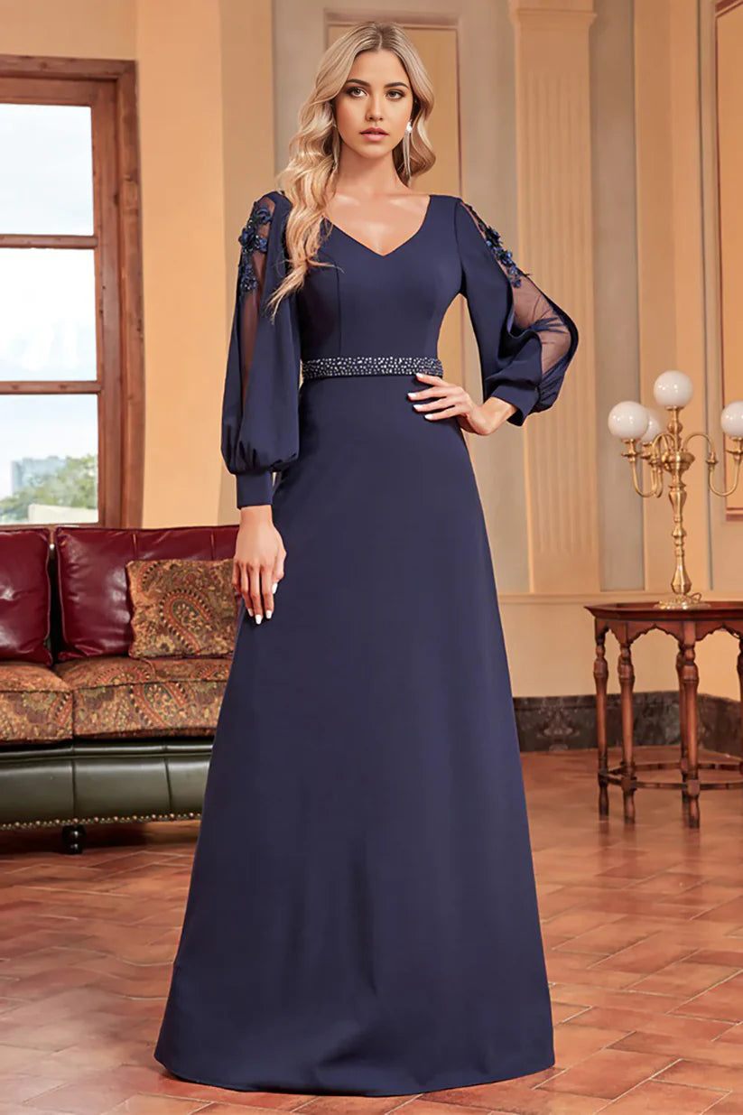 Model wearing an elegant A-line mother of the bride dress with long sleeves and beading.