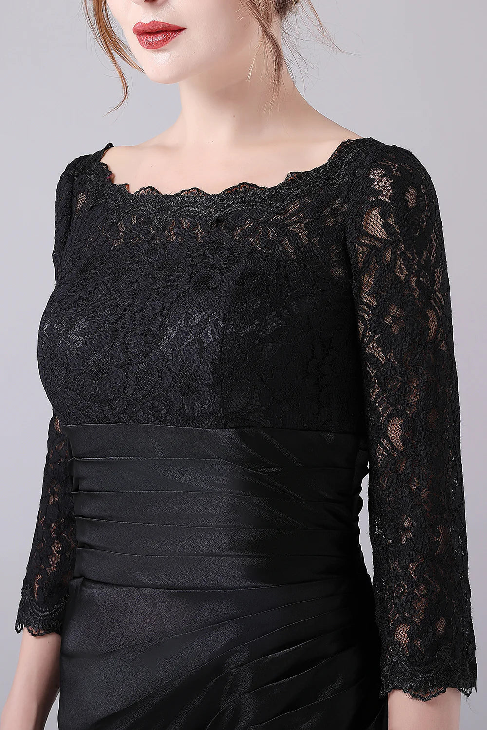 Close-up of the V-neckline and long sleeves on the black dress.