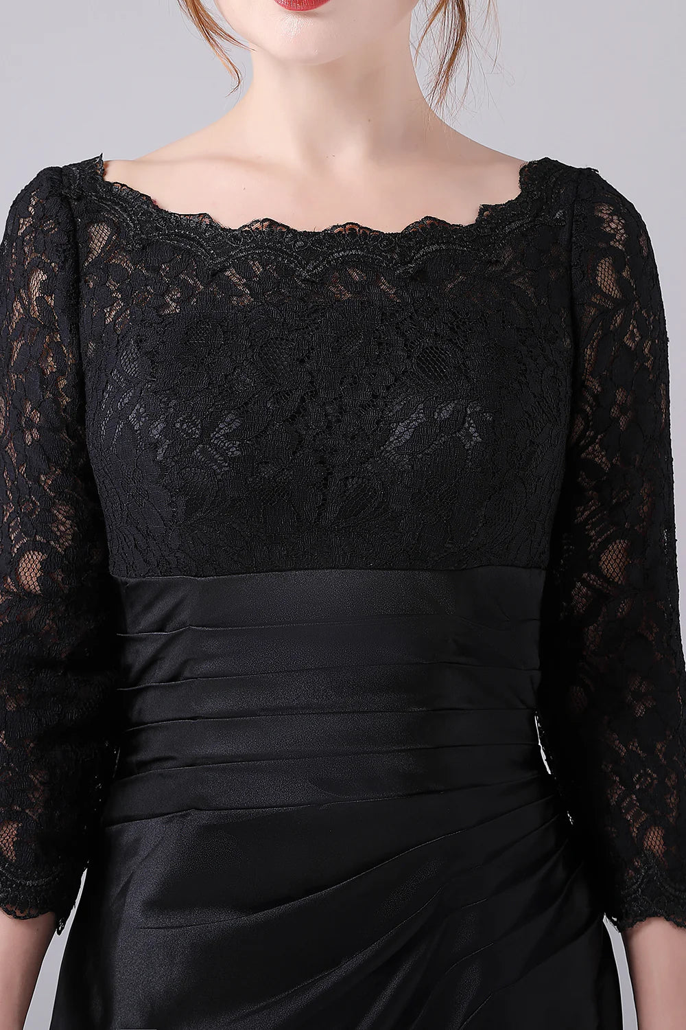 Woman posing in the black A-line mother of the bride dress.
