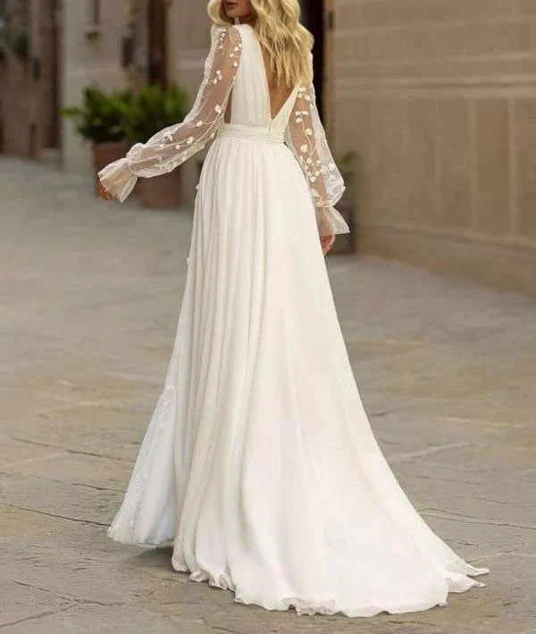 Close-up of the V-neck lace detail on the long sleeve wedding gown.