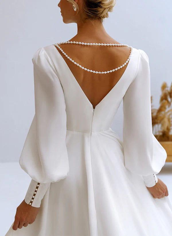 Back view of an A-line V-neck long sleeve chiffon wedding dress.