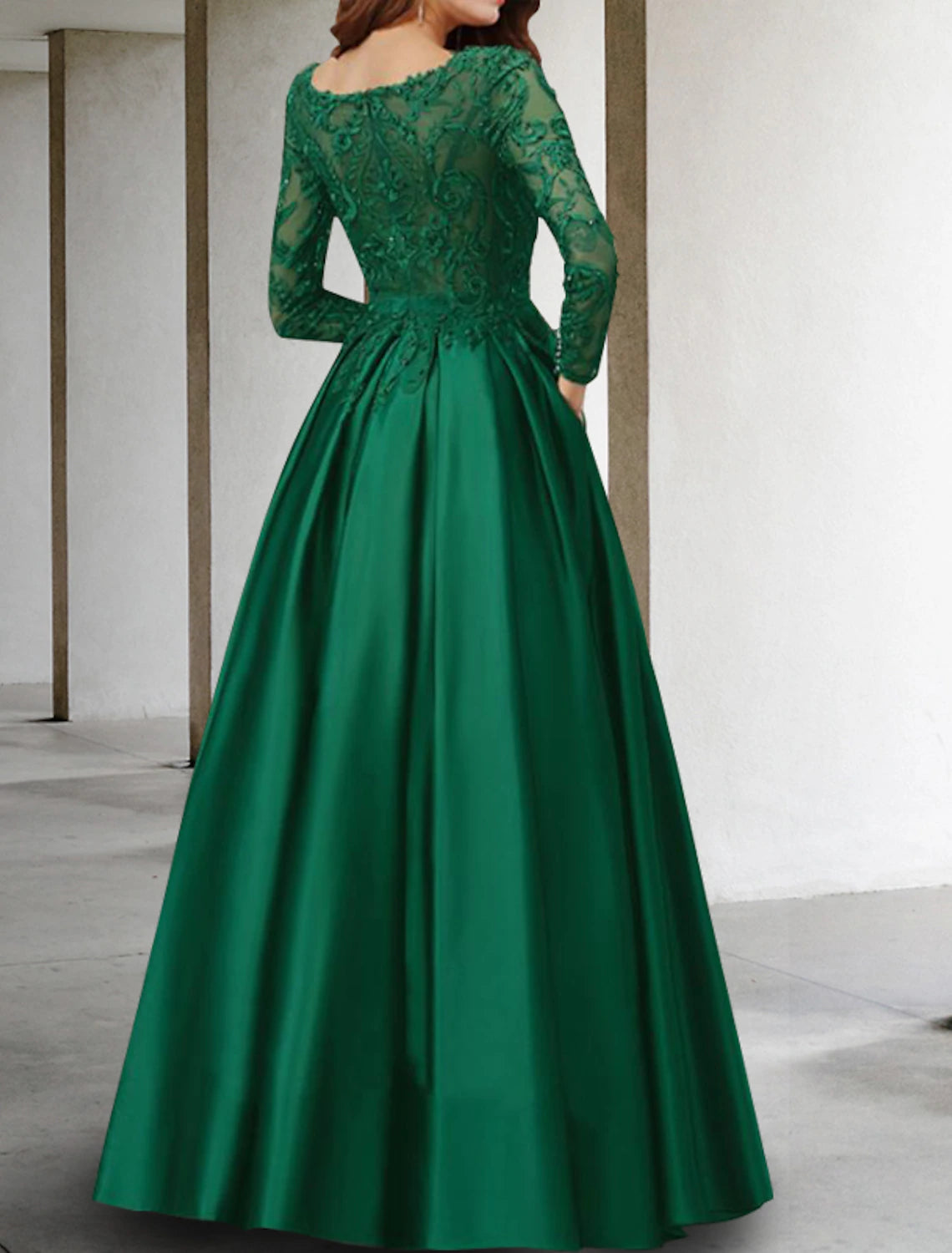 Close-up of the V-neckline and delicate lace appliques on the chiffon fabric of the dress.