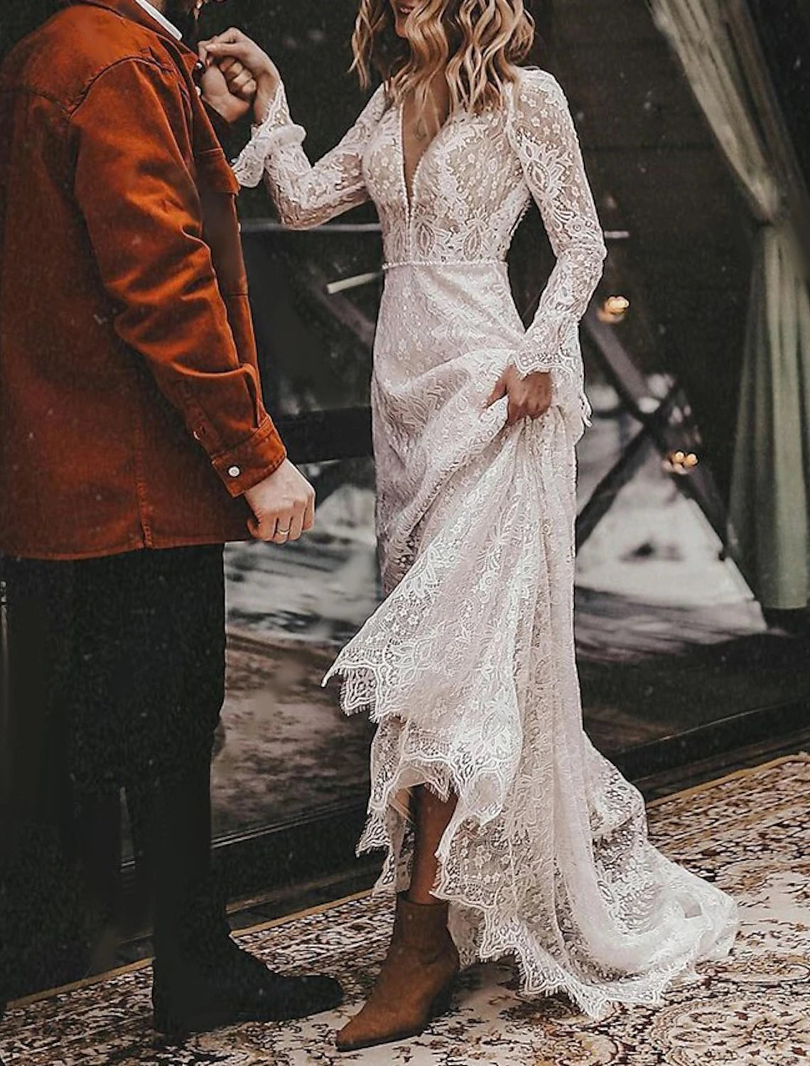 Close-up of the V-neckline and long sleeves of the elegant wedding dress.