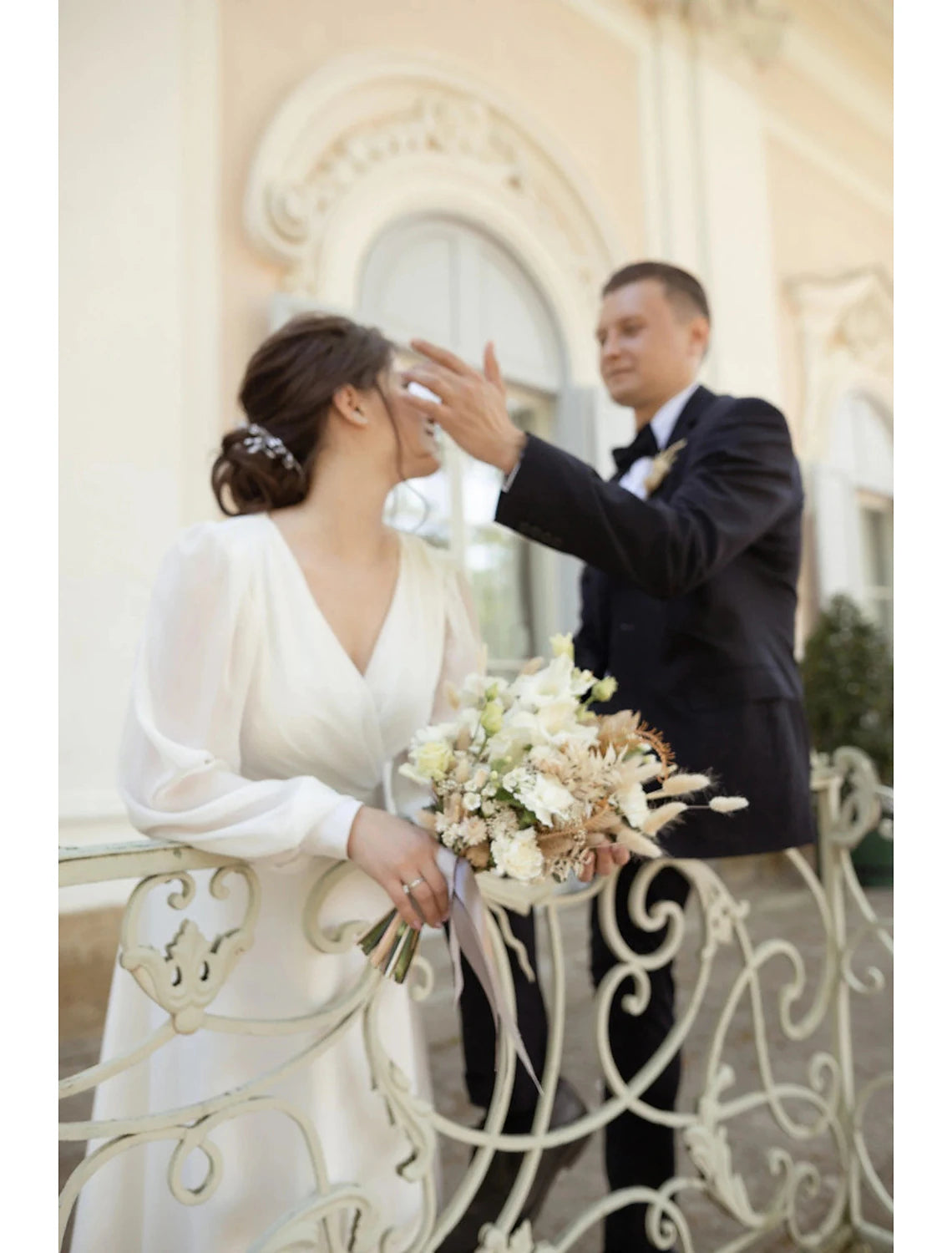 Back view of the A-Line V-neck long sleeve white chiffon wedding gown.