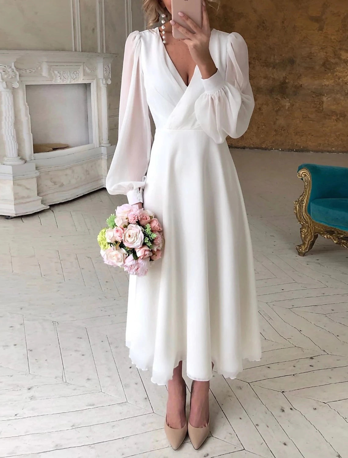 Side view of the A-line V-neck long sleeve white chiffon wedding gown.