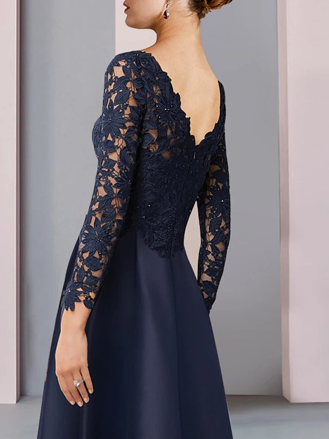 Back view of the A-line dress showing high-low hem and lace details.