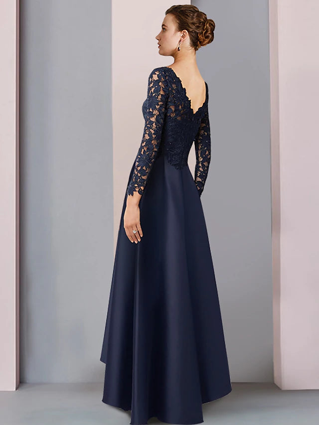 Close-up of the dress details, including lace appliques and V-neck.