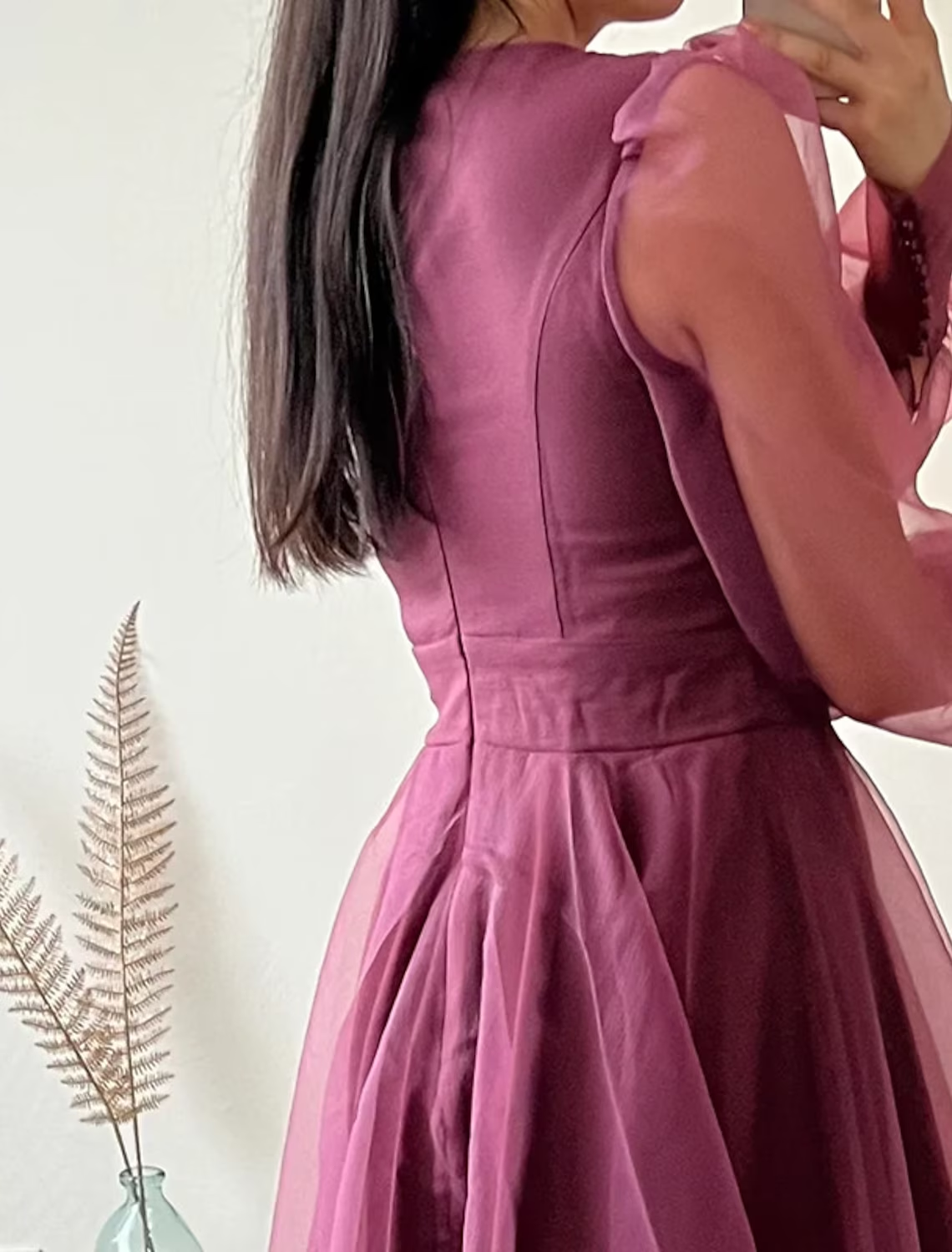 Side view of the minimalist V-neck long sleeve tea length dress.