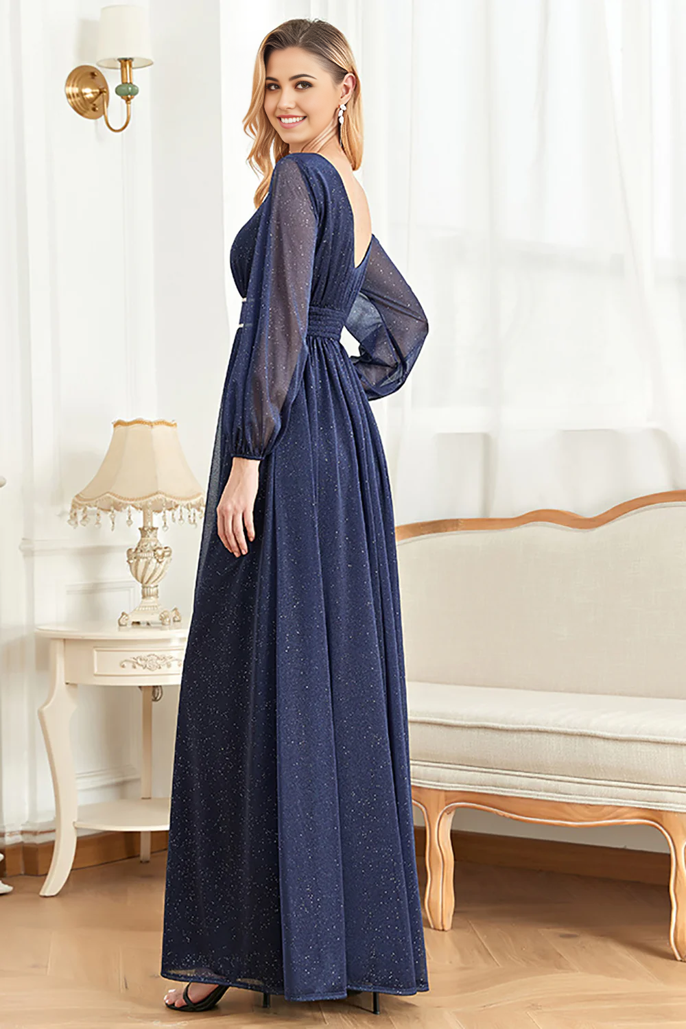 Side view of a woman in a navy long sleeve A-line formal dress.