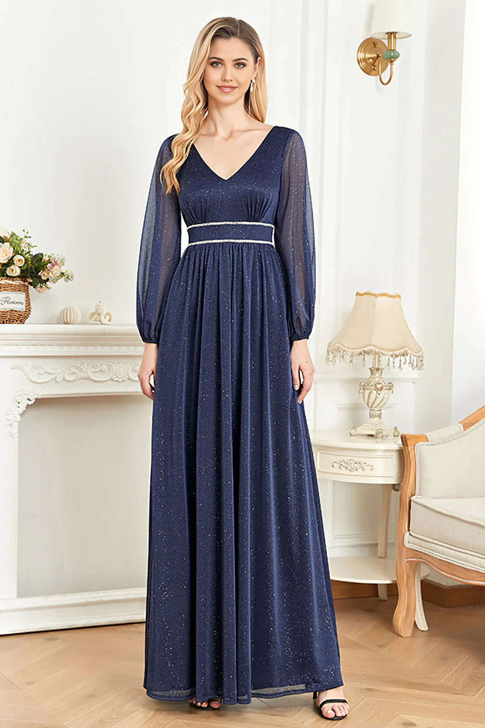Back view of a woman in an elegant navy V-neck long sleeve gown.