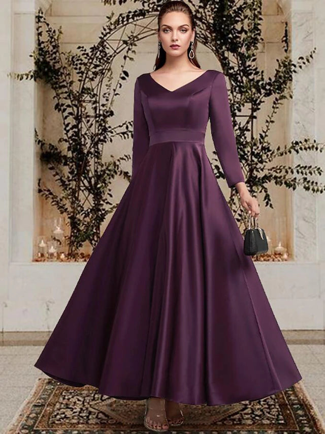 Close-up of the satin fabric and pleated detail on the dress.