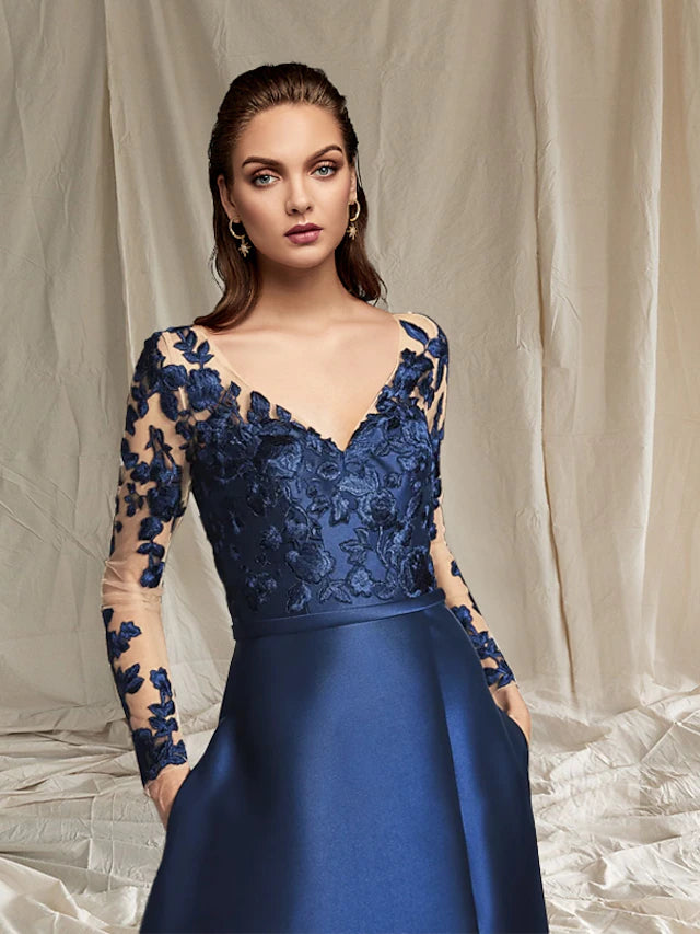 Detail of appliques and split front on the satin and lace dress.
