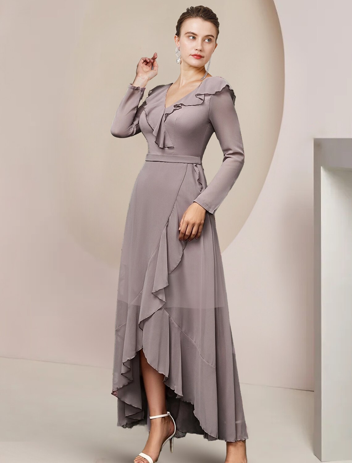 Close-up of V-neckline and ruffled long sleeves on chiffon dress.