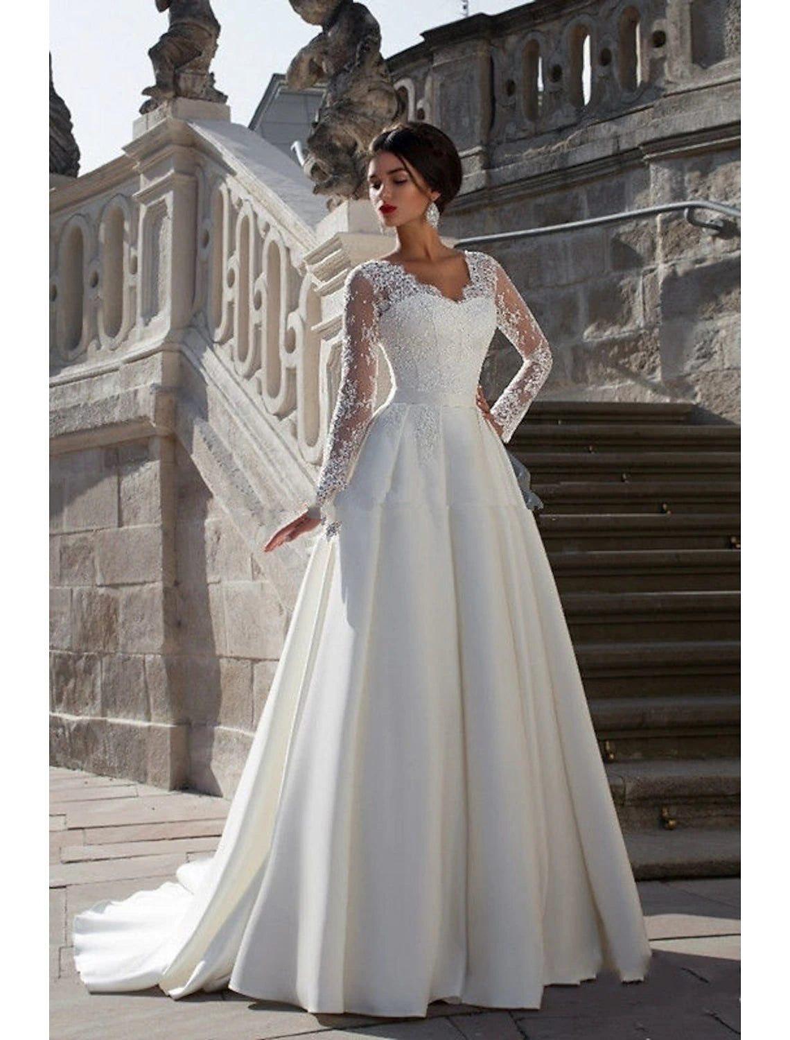 Elegant A-Line V-Neck long sleeve satin wedding dress with appliques and court train.