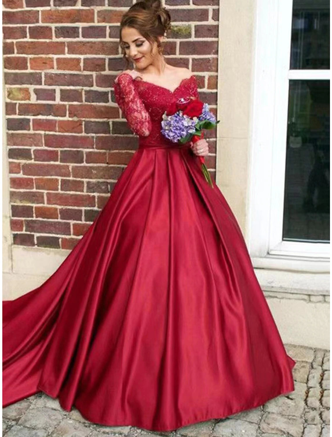 Elegant A-line satin evening gown with V-neck, long sleeves, and floral appliques.