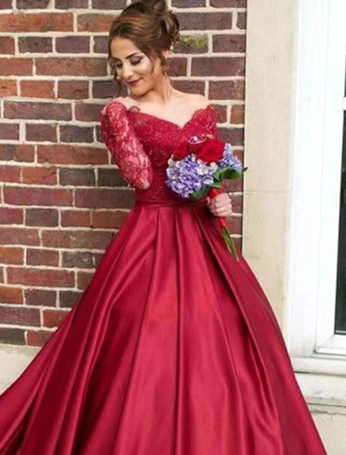 Back view of an A-line satin gown showing the chapel train and floral appliques.