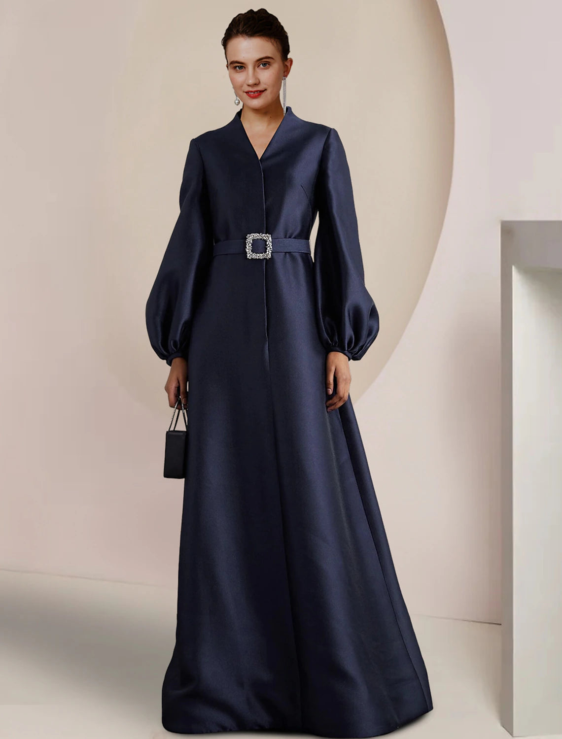 Elegant A-line satin gown with V-neck and long sleeves, featuring pearl and crystal embellishments.