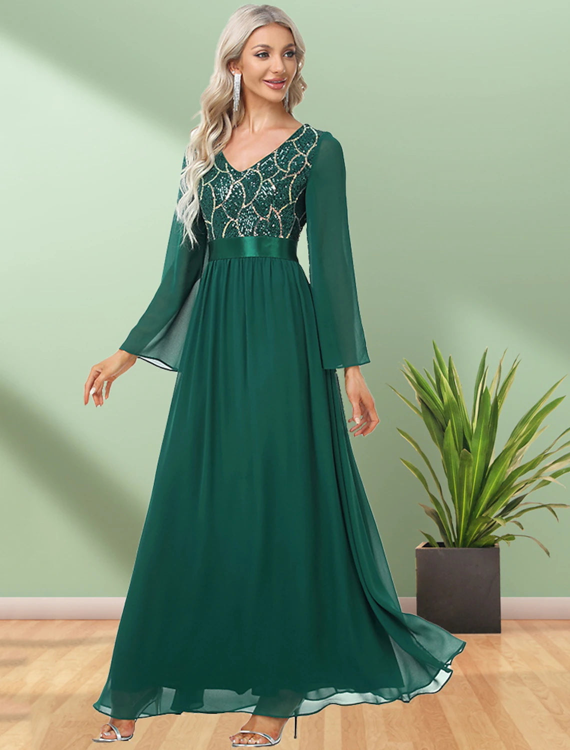 Close-up of the sequin detailing on the long sleeve of the chiffon evening gown.