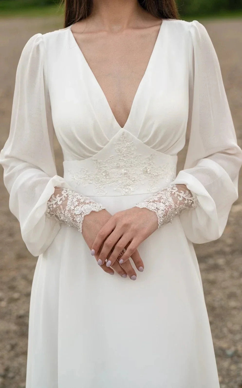 Close-up of the A-line wedding dress, highlighting the V-neckline and sequin embellishments.