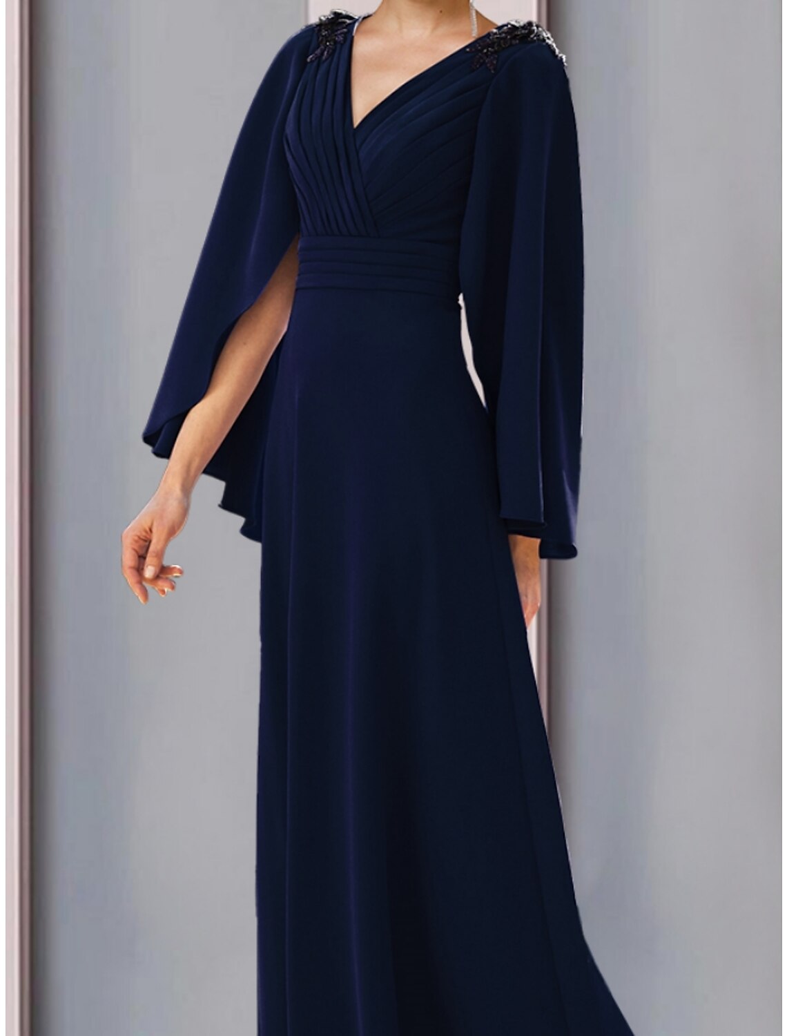 Side view of the A-line chiffon gown, showcasing the sweep train and flowing silhouette.