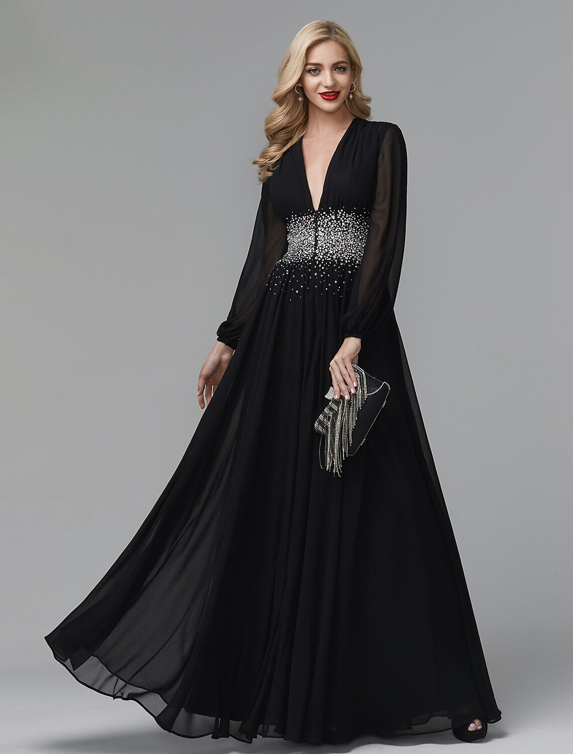 Woman posing in a formal floor-length chiffon gown with sequin embellishments.