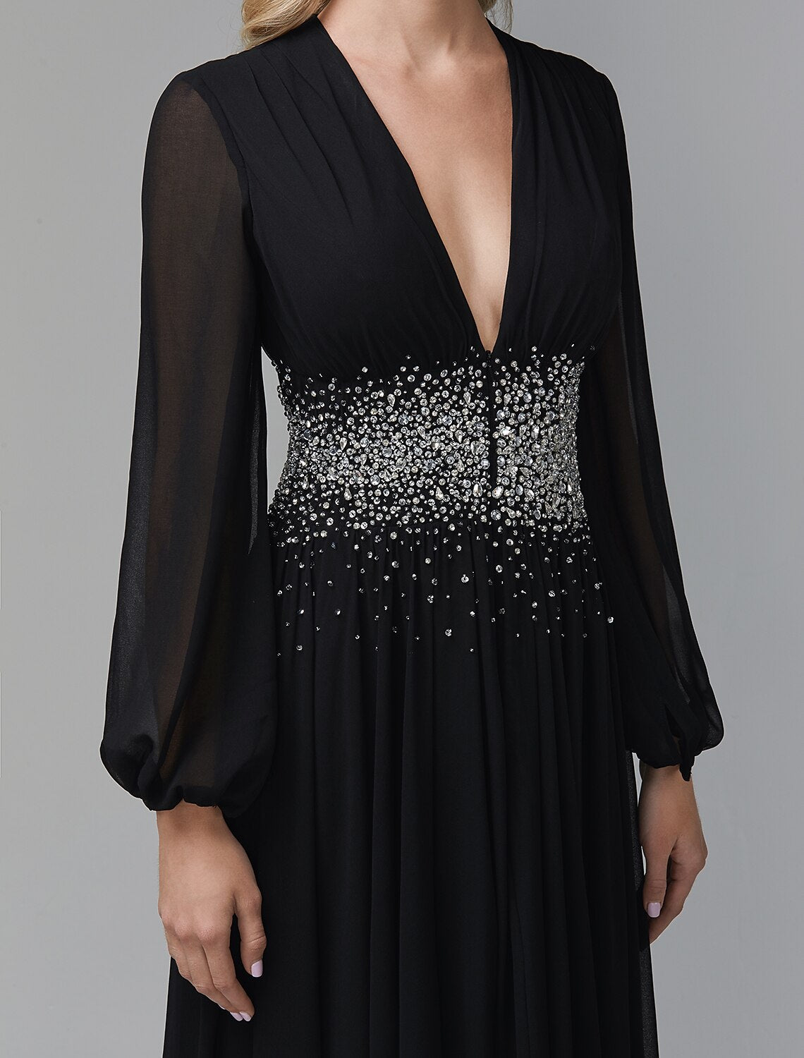 Woman in a sophisticated long sleeve formal dress.