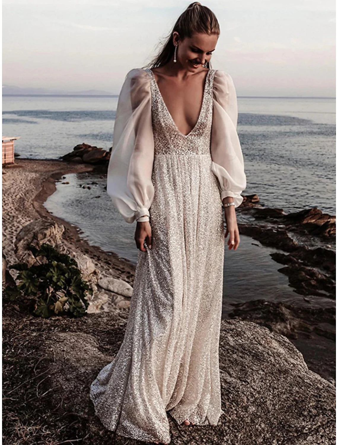 Side view of A-line sequined bridal gown with pleats.
