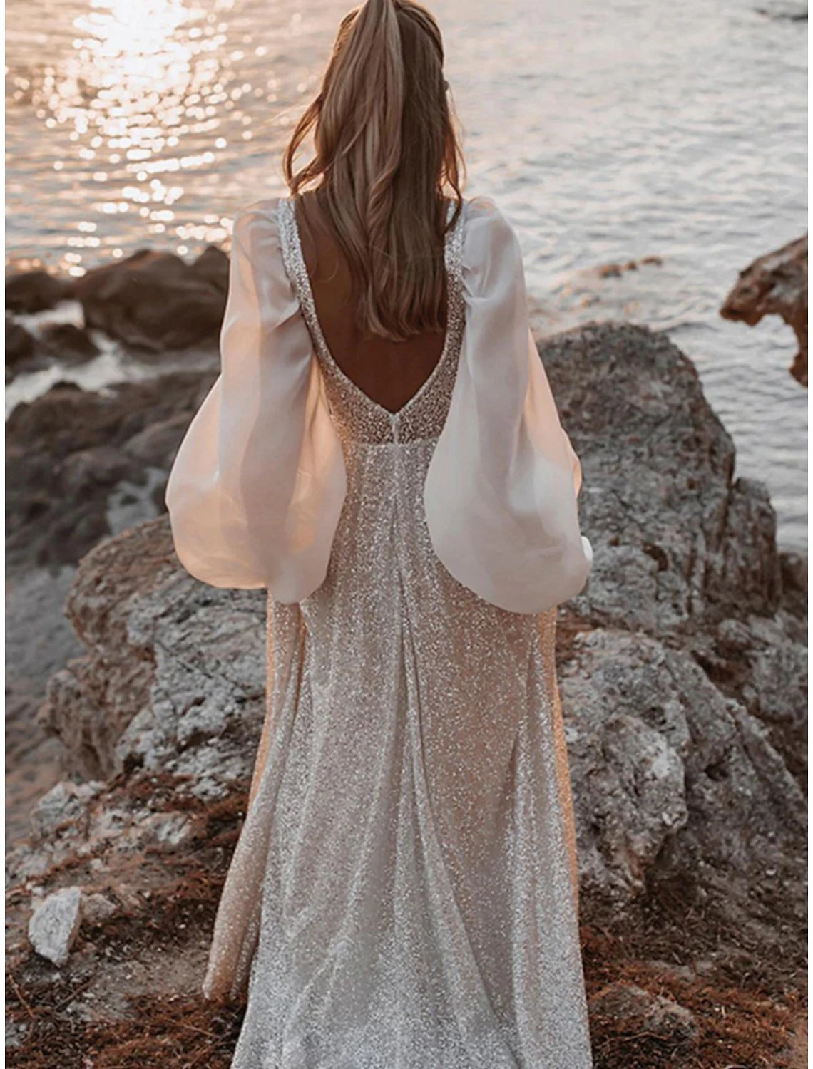 Close-up of sequin details on the long sleeve boho wedding dress.