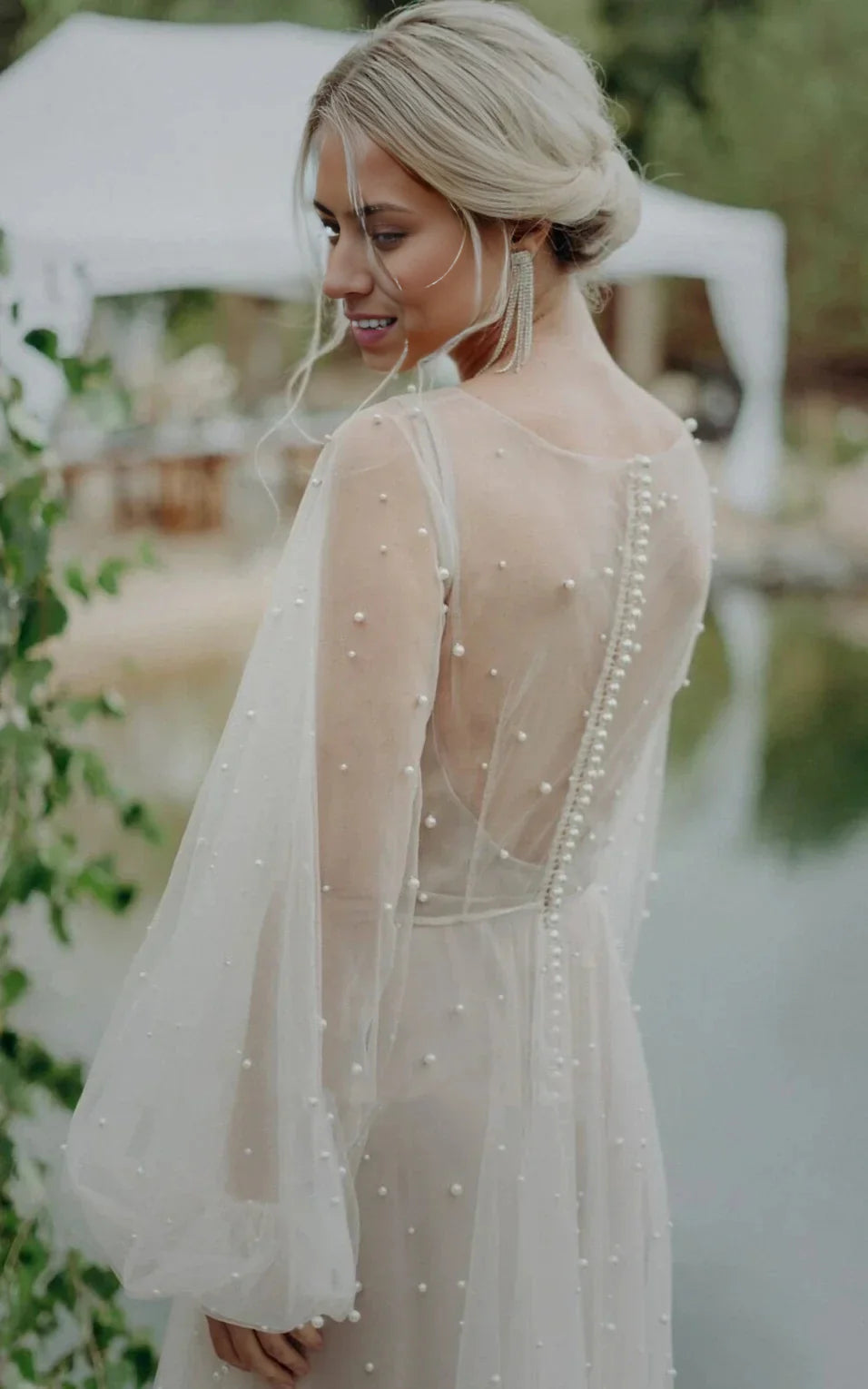 Back view of an A-line V-neck long sleeve tulle wedding dress.