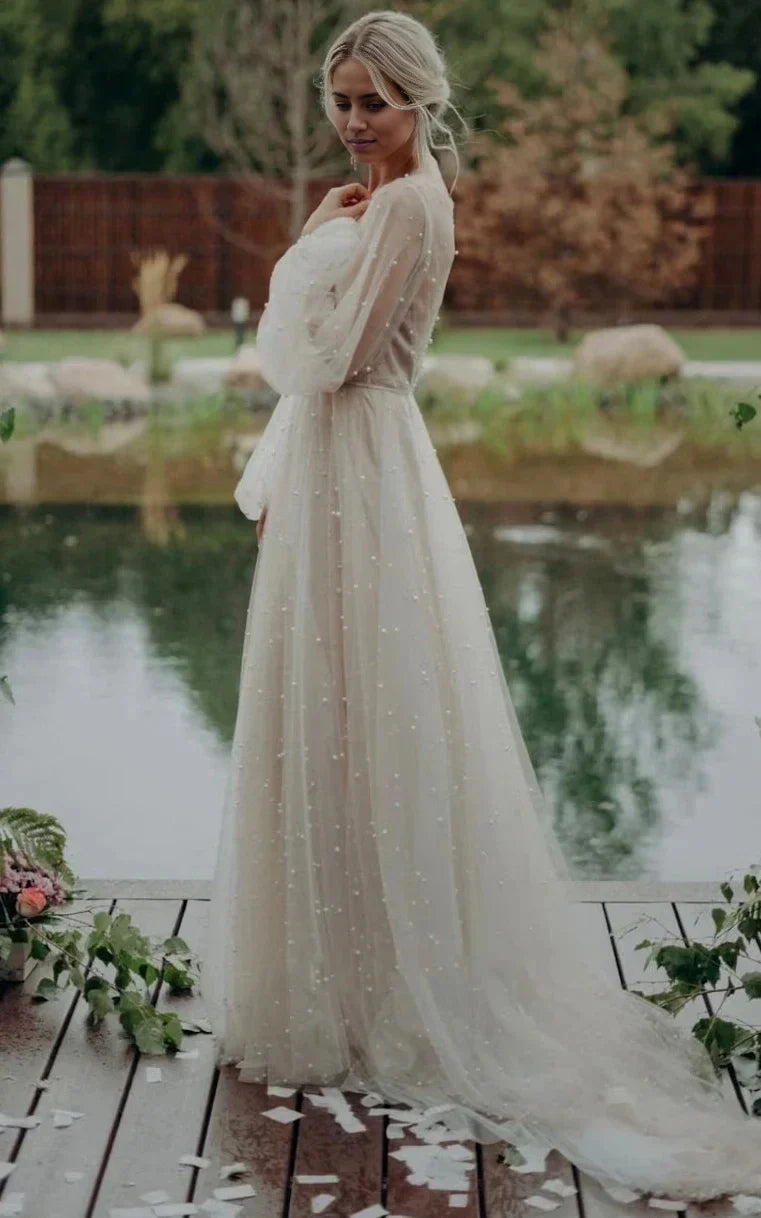 Side view of an A-line V-neck long sleeve tulle wedding dress.