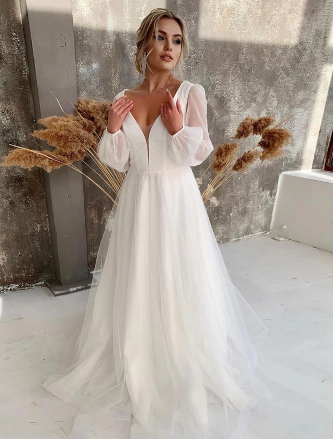 Elegant A-Line V-neck long sleeve tulle wedding gown.