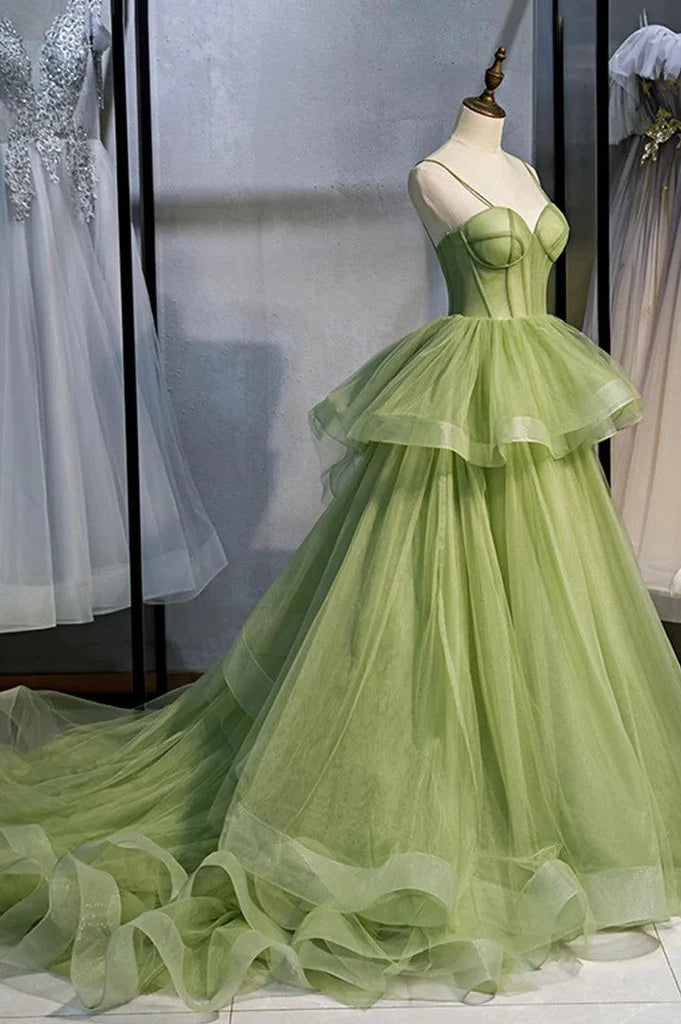 Back view of an A-line tulle prom dress showing the long train and elegant silhouette.