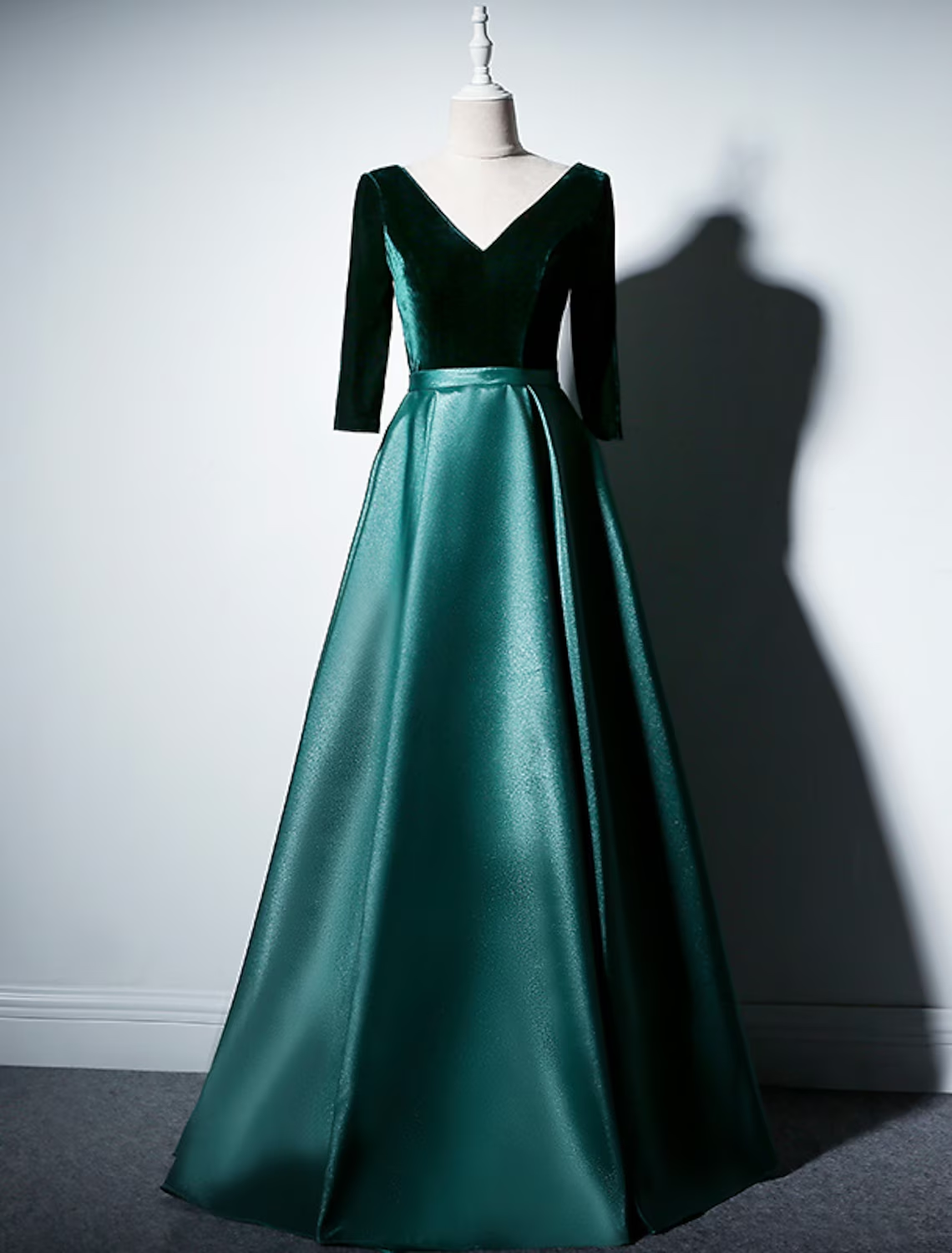 Full view of a sophisticated A-line velvet pleated gown.