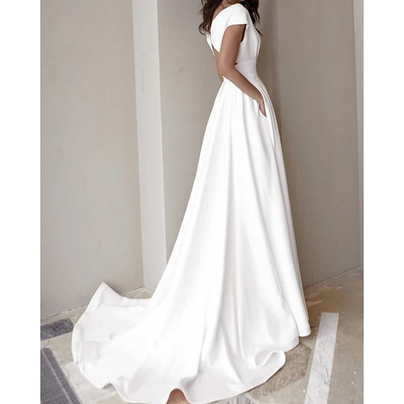 Close-up of the V-neck and long sleeves of an A-line wedding dress.
