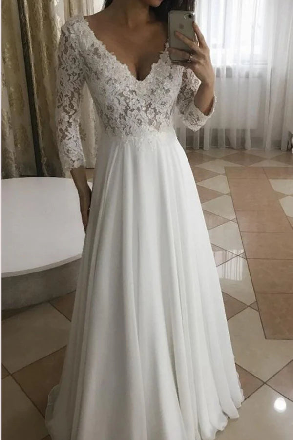 Model wearing a white A-line V-neck long sleeve lace wedding dress.