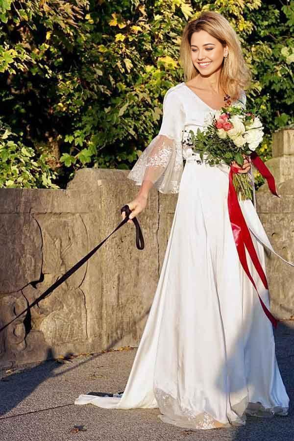 Elegant A-line V-neck long sleeves satin wedding dress with delicate lace details.