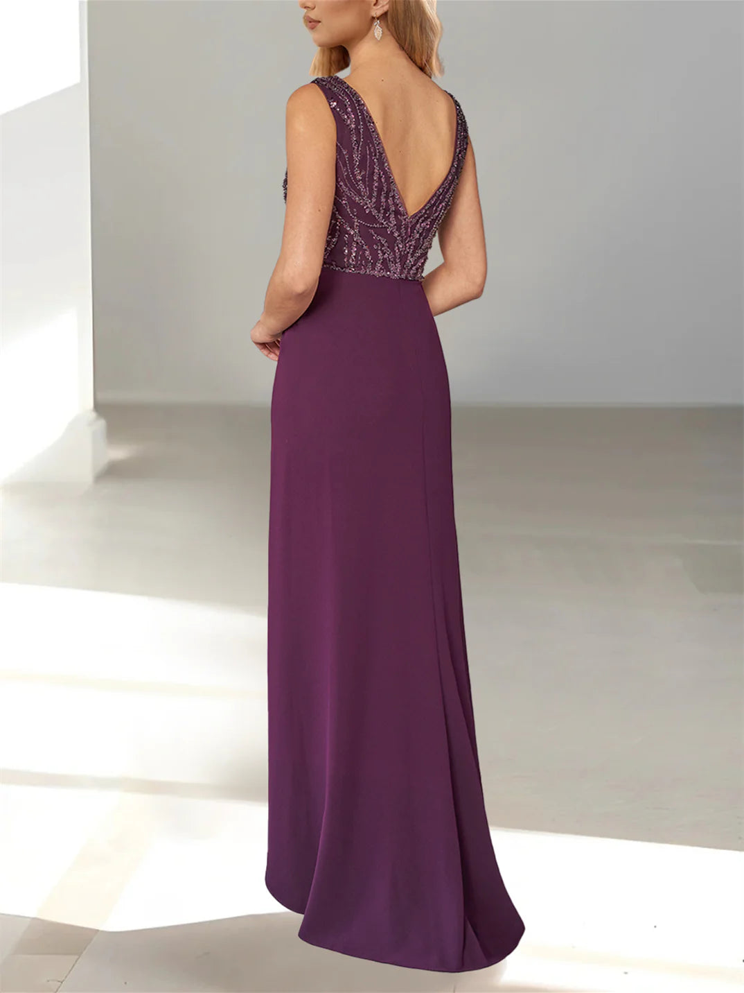 Back view of a woman in a formal A-line V-neck gown.