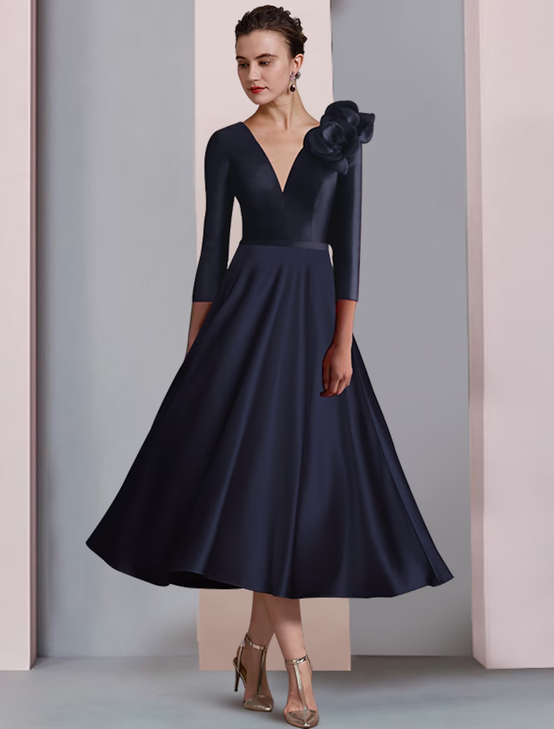 Woman wearing an A-line satin tea length dress, showing the side profile and 3/4 sleeves.