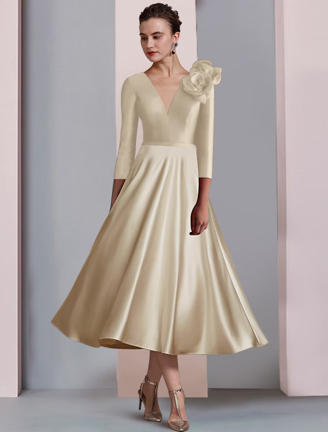 Back view of an A-line satin tea length dress, highlighting the fabric and pleats.