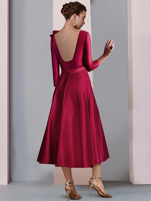 Close-up of the satin fabric and pleat detail on the A-line dress.