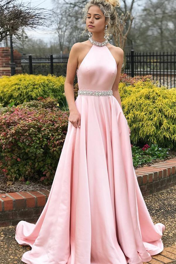 Elegant pink A-line prom dress with open back and intricate beading.