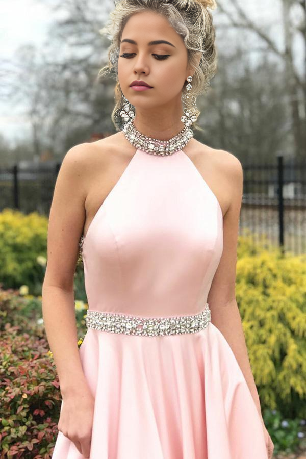 Back view of the pink A-line prom dress showcasing the open back design.
