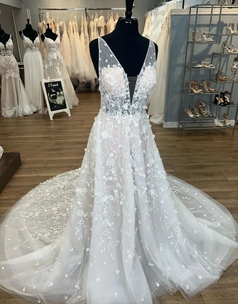 Elegant A-Line V-neck wedding dress with open back and chapel train.