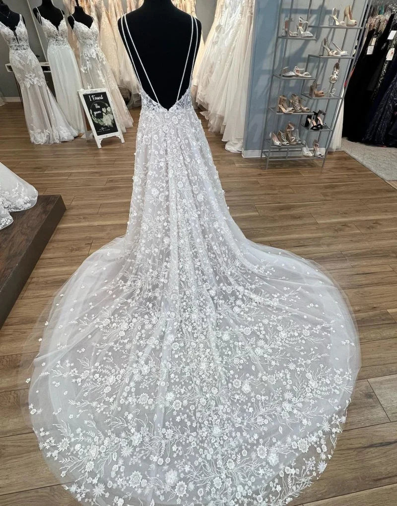 Rear view of A-Line V-neck wedding dress showing open back and chapel train.