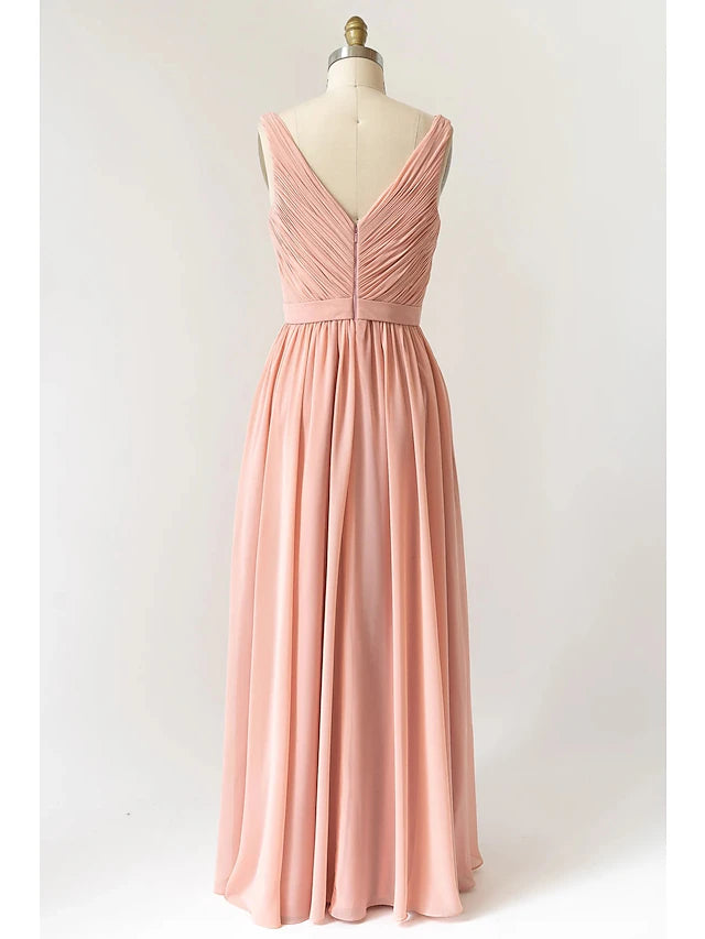 Close-up of the V-neckline and pleated detail on a chiffon dress.
