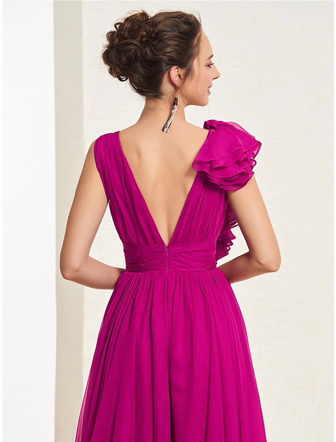 Back view of A-line V-neck gown showing open back and sweep train.