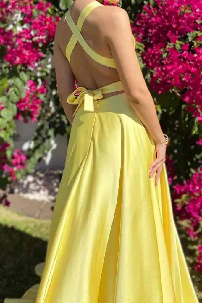 Side view of an A-line V-neck prom dress featuring an open back and high slit.