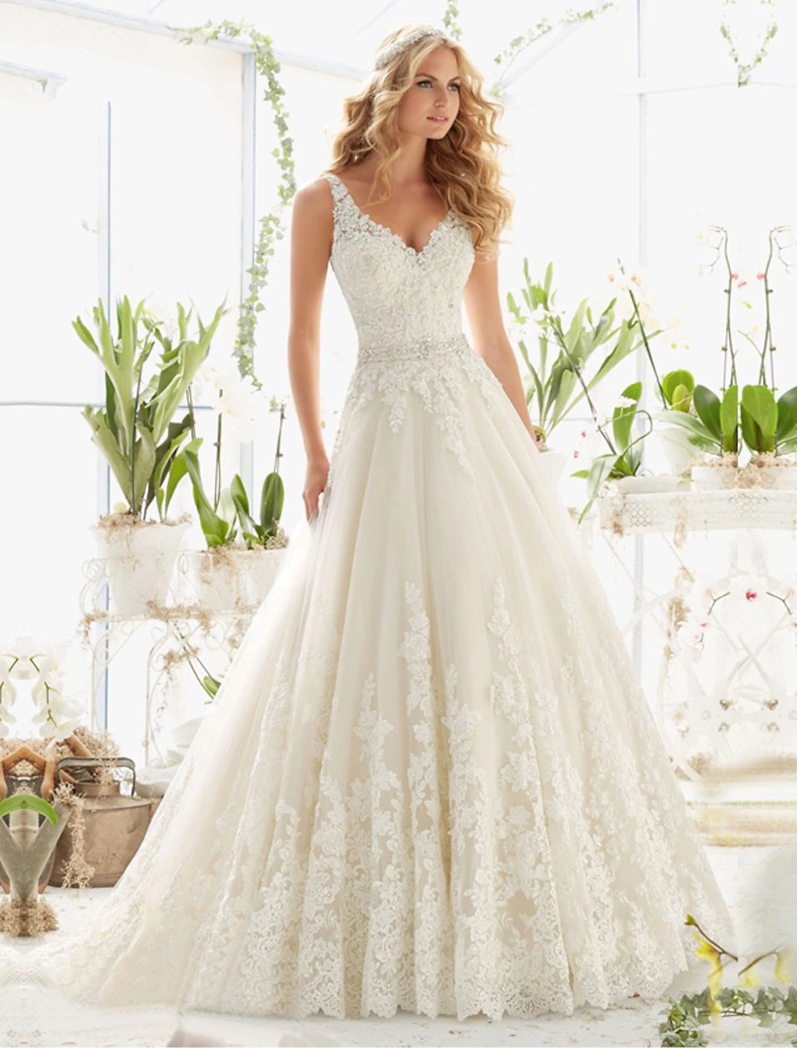 Elegant A-Line V-neck lace wedding dress with open back and court train.