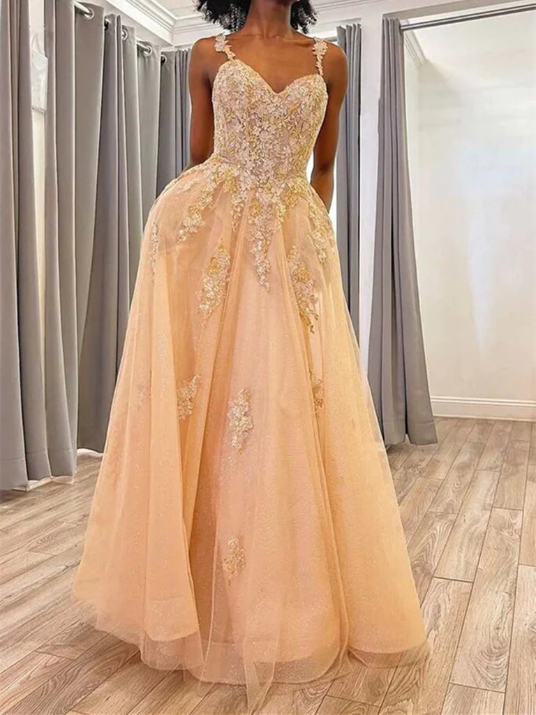 Woman wearing an elegant A-line lace tulle prom dress with a V-neck and open back.